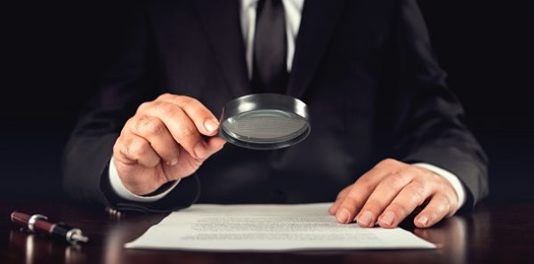 Businessman Reading Contract Details Before Signing